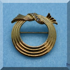 J27. Goldtone circle pin w/white stones marked Avon 1”w - $10